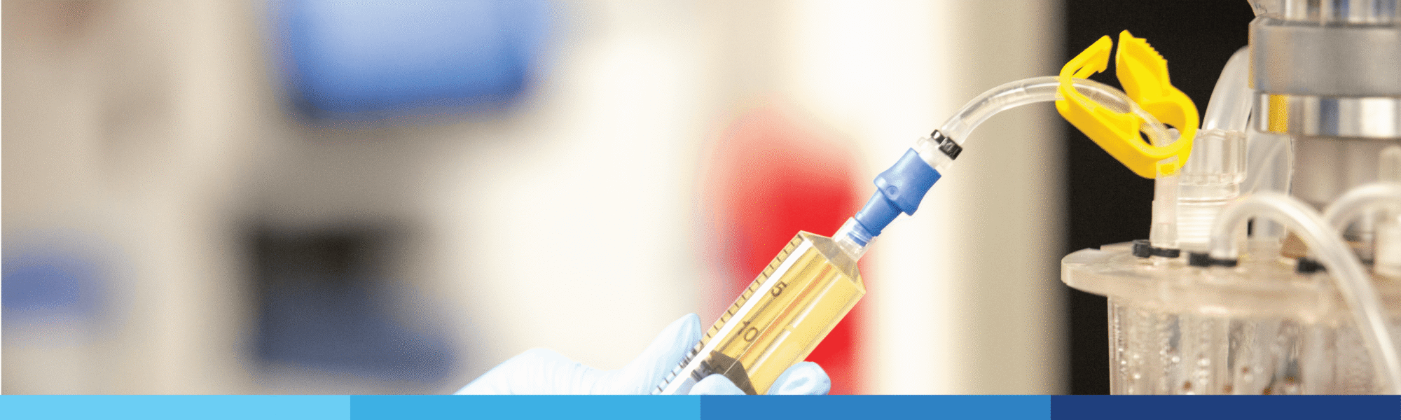 Close-up of a syringe filling equipment with tubing in a lab