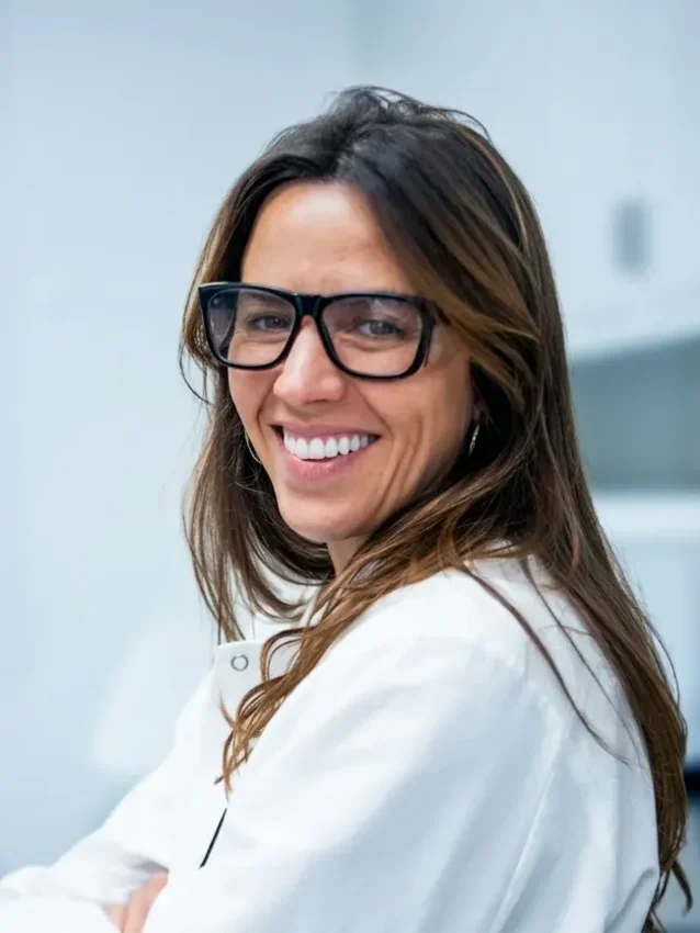 Smiling woman wearing glasses in an office setting