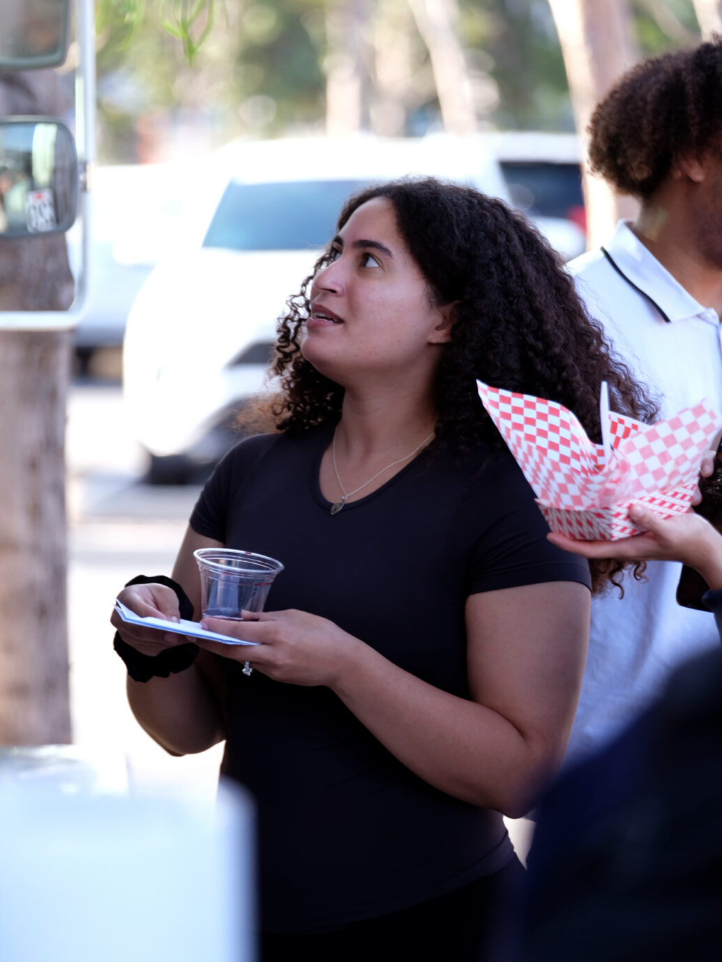 Two people looking upward outdoors during a company event