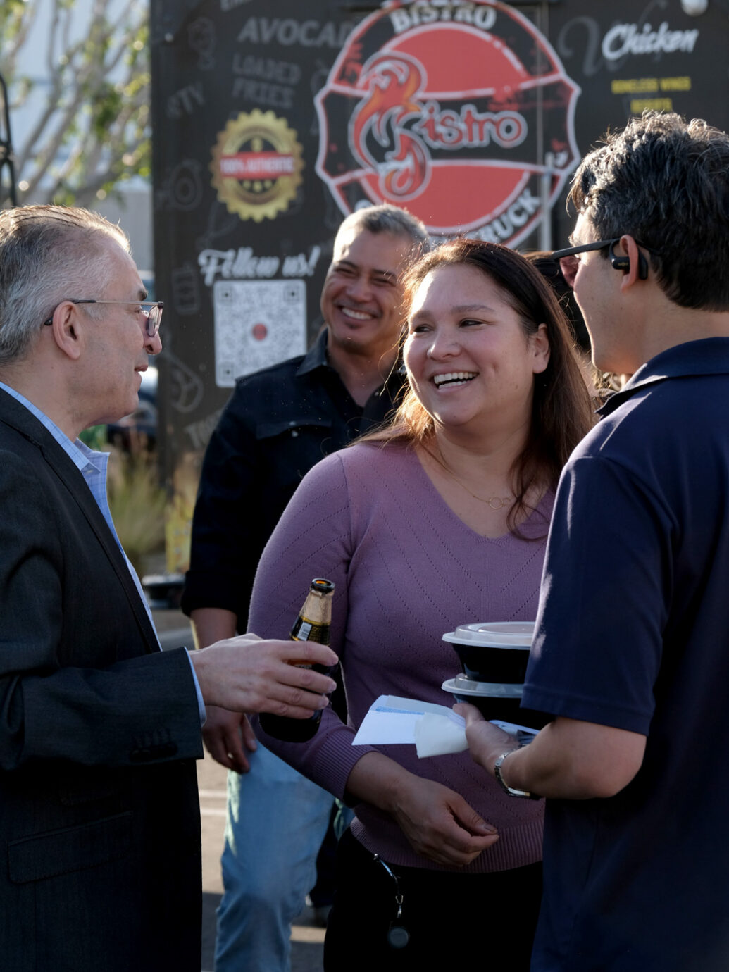 Employees standing in front of a food truck at a company event