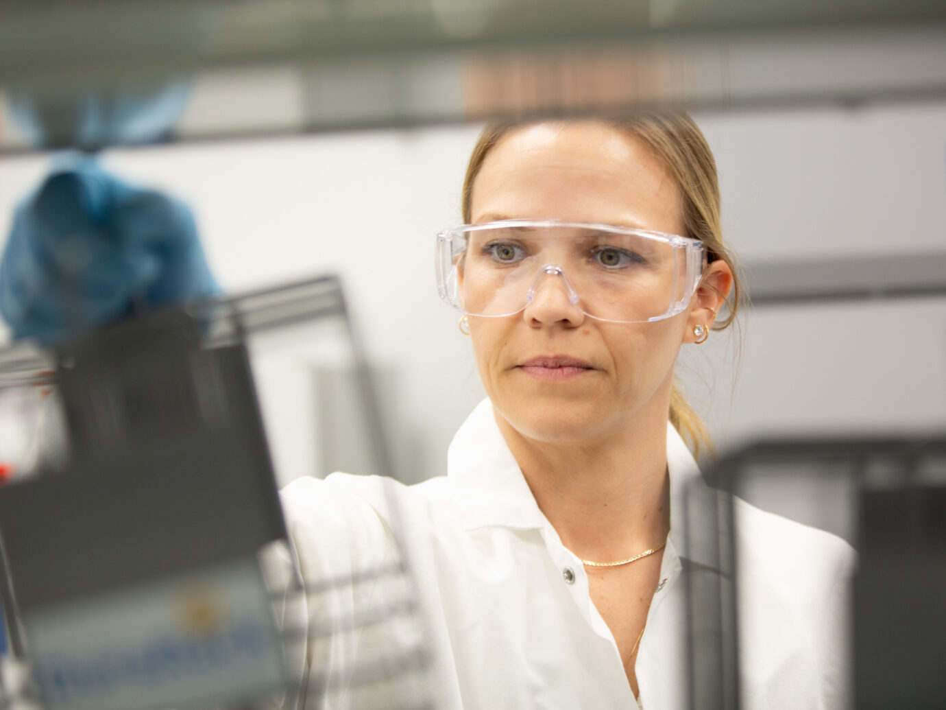 Close-up of a female lab worker wearing safety goggles in a laboratory