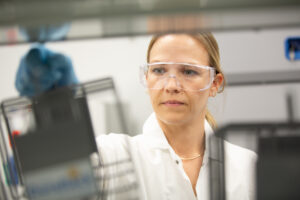 Close-up of a female lab worker wearing safety goggles in a laboratory