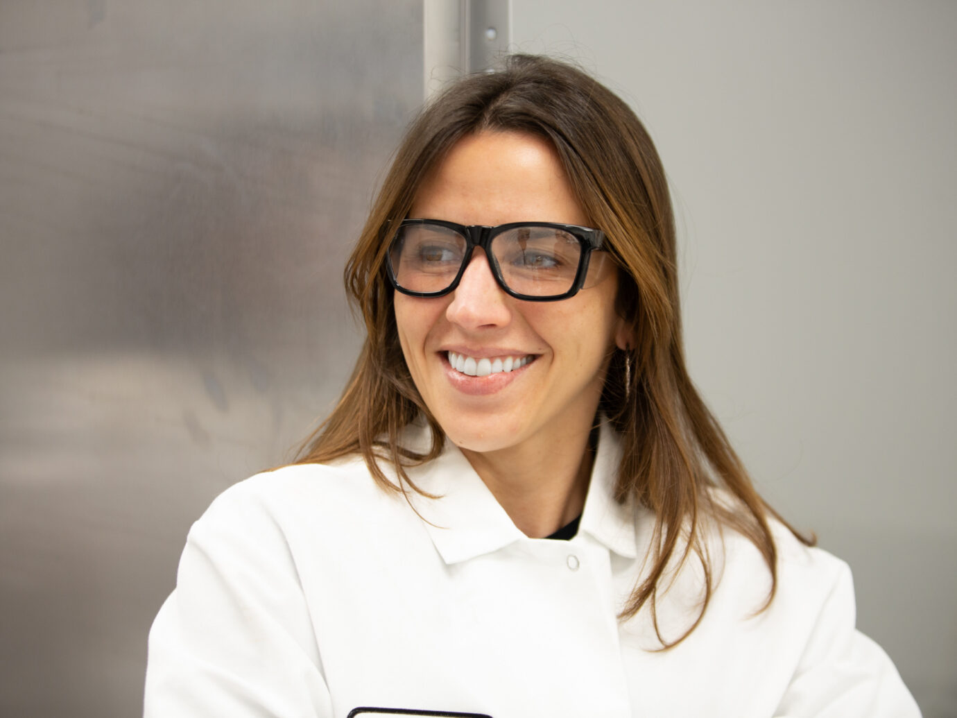 Smiling woman wearing glasses in an office setting
