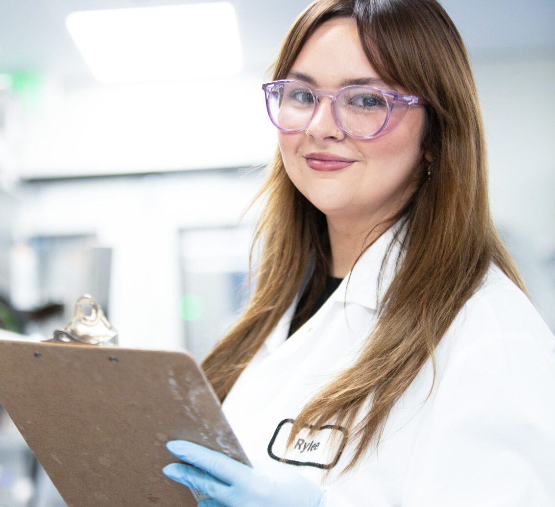 Close-up of a woman wearing glasses in an office setting