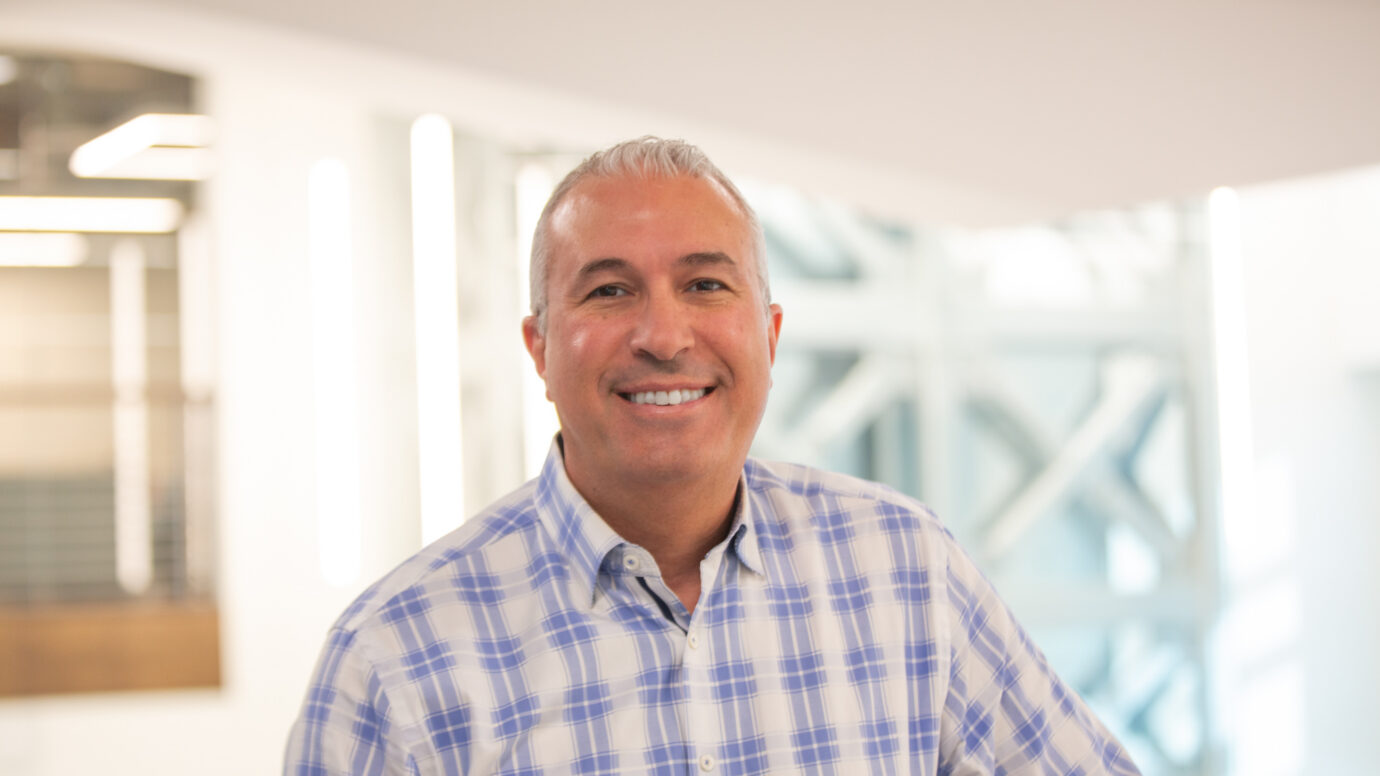 Smiling man in an office setting, close-up portrait