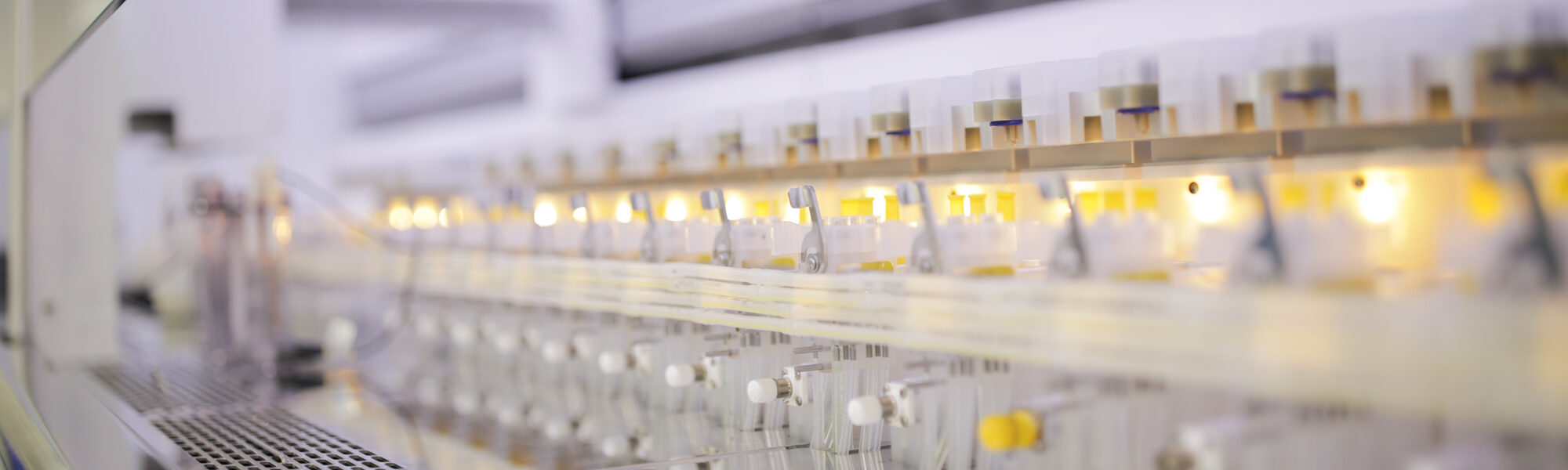 Row of illuminated sample vials in an automated laboratory instrument